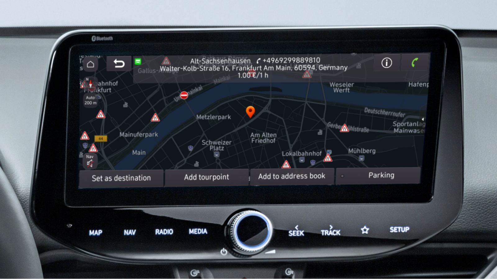 Close-up of a Hyundai touchscreen showing the location of a parking garage including cost per hour.