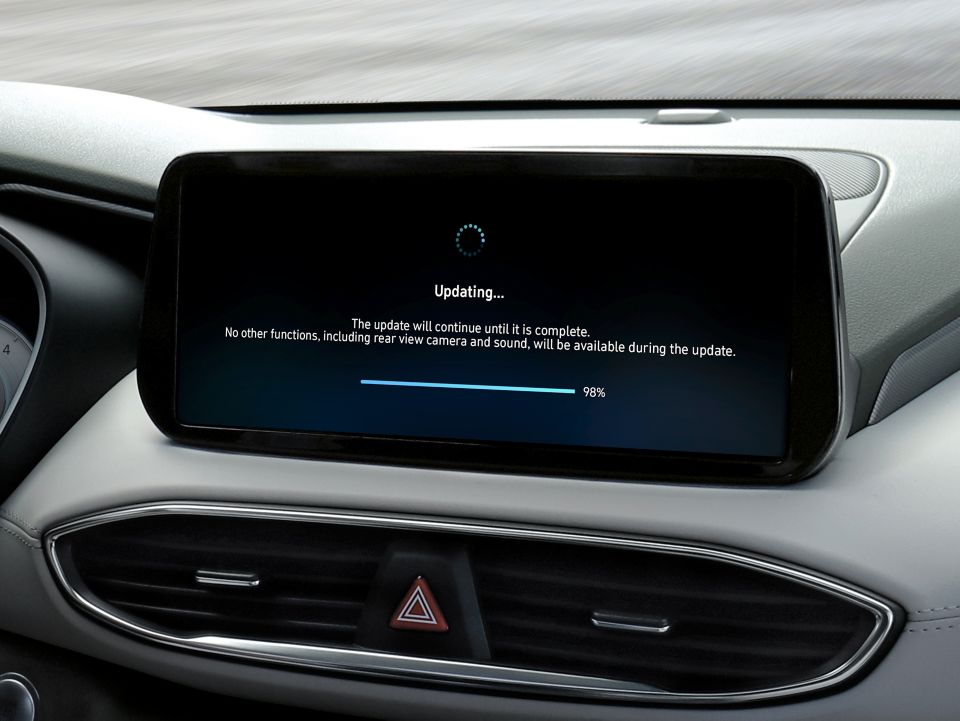 A centre touch screen inside a Hyundai vehicle with the screen showing a software update.